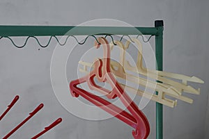 Red and white cloth hanger in the green clothing rack