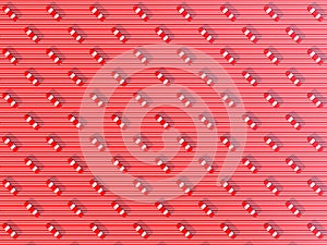 Red and white colored capsules on red and white striped background, symmetrically arranged next to each other