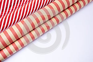 Red and white and craft guft wrapping paper rolls in white background with copy space . photo