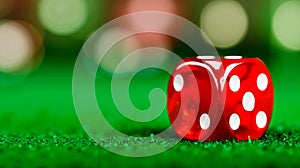 A red dice sitting on top of a green table