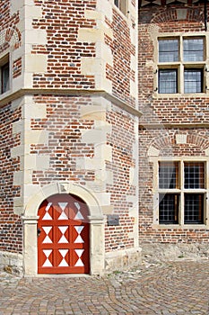 The red-white door in the old stoned wall