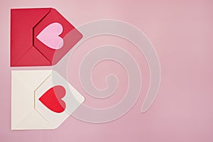 Red and White Envelopes with red and pink heart for valentine day on pink background Copy space horizontal