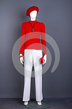 Red and white female apparel on mannequin.