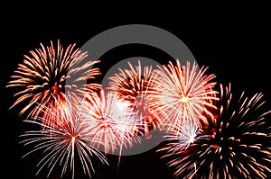 Red and white fireworks display on dark sky background