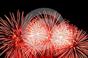 Red and white fireworks display on dark sky background