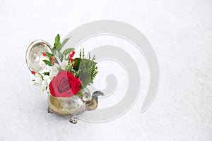 Red and White floral arrangement in antique teapot