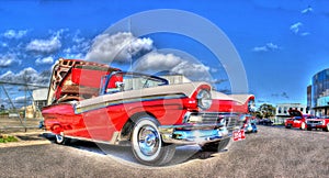 Red and white Ford Fairlane Skyliner convertible