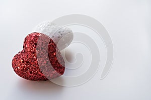 Red and White Glitter Hearts on a Textured White Background