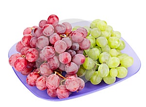 Red and white grapes bunches on plate
