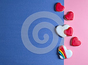 Red and white heart shapes Sugar cookies on blue and pink background