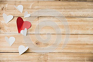 Red and white hearts paper on brown wooden table, Copy space to put messages on the Valentine`s Day