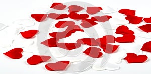 The Red and white hearts on white textured fabric background