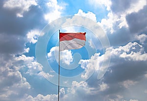 Red and White, Indonesia National Flag High on The Sky Blowing by Wind on 17 August During Independence Day Celebration