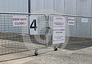 Red and white Keep Gate Closed and Unauthorised Entry Prohibited