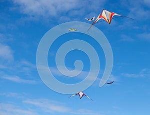 Red and white Kites flying in blue sky with cloudy in Andora, Italy