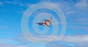 Red and white Kites flying in blue sky with cloudy in Andora, Italy