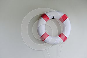 Red and White Lifebuoy Ring Hanging on the Wall at Swimming Pool