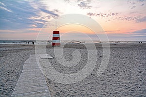 Red-white lifeguard tower on the beach of Henne Strand, Jutland Denmark photo