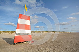 Red-white lifeguard tower on the beach of Henne Strand, Jutland Denmark
