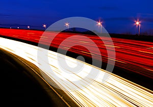 Light trails caused by multiple car headlights and tail lights