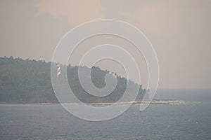 Red White Lighthouse in Forest on North Bay Island with Ocean and Cloudy Sky with Thunder Storm - Andaman Nicobar, India