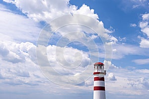 Red White lighthouse with sky and clouds photo