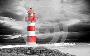 Red and white Lighthouse on a stormy day photo