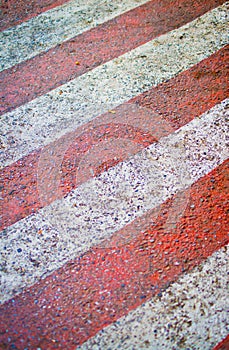 Red with white lines on the road.