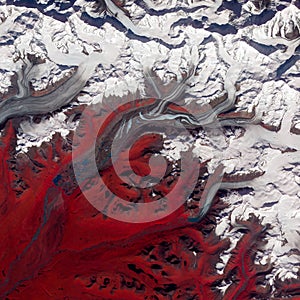 Red white marbled surface of Susitna Glacier, Alaska, top view of ice texture. Elements of this image furnished by NASA