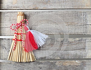 Red and white martenitsa on old wooden background