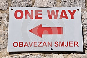 Red and White One Way sign with arrow pointing left. From Dubrovnic Old Town, Croatia.