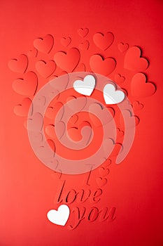 Red and white paper background, cut out hearts are lined up in the shape of a balloon. Words I love you. Set of 4 photos.