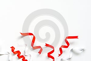 red and white paper ribbons on white paper background with copy space, Christmas background concept