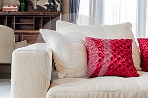 Red and white pillow on white sofa at home