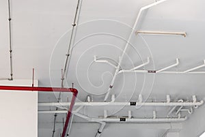Red and White Pipes under Ceiling in Building