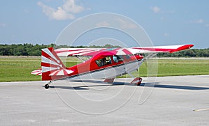 Red and white plane taxying