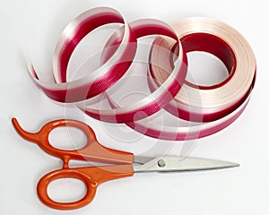 Red and white ribbon with scissor