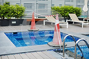 A red and white ribbon stretched over the pool prohibits entry to the pool photo