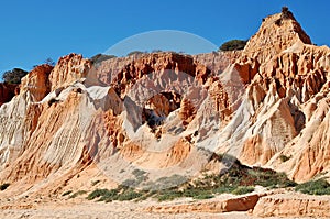 Red/white rock formations on the Falesia beach in Albufeira - Portugal