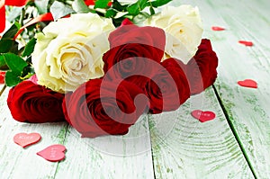 Red and white roses on wooden background