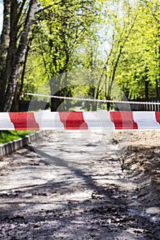 Red and white safety tape in the park