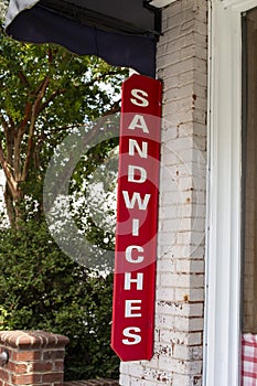 A red and white Sandwiches restaurant sign