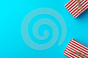 Red and white striped gift box on blue background