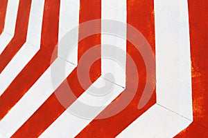 Red and white stripes closeup background. Painted concrete wall