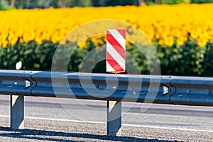 Red and white stripes traffic sign on center of highway