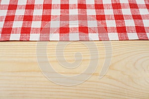 Red and white tablecloth on white wooden table. Selective focus, copy space