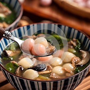 Red and white tangyuan with savory soup