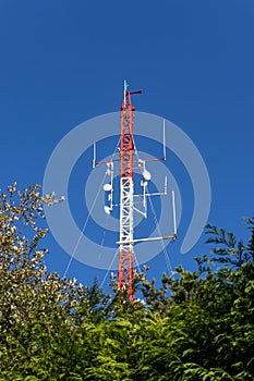 Red and white telecommunication antenna mast or mobile tower