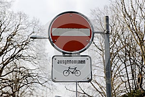 Red and white traffic sign, one-way street, motor vehicles are not allowed to pass, except bicycles