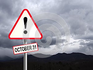 Red and white UK triangular road sign with a Brexit Danger Warning Ahead. October concept. Stormy sky behind.